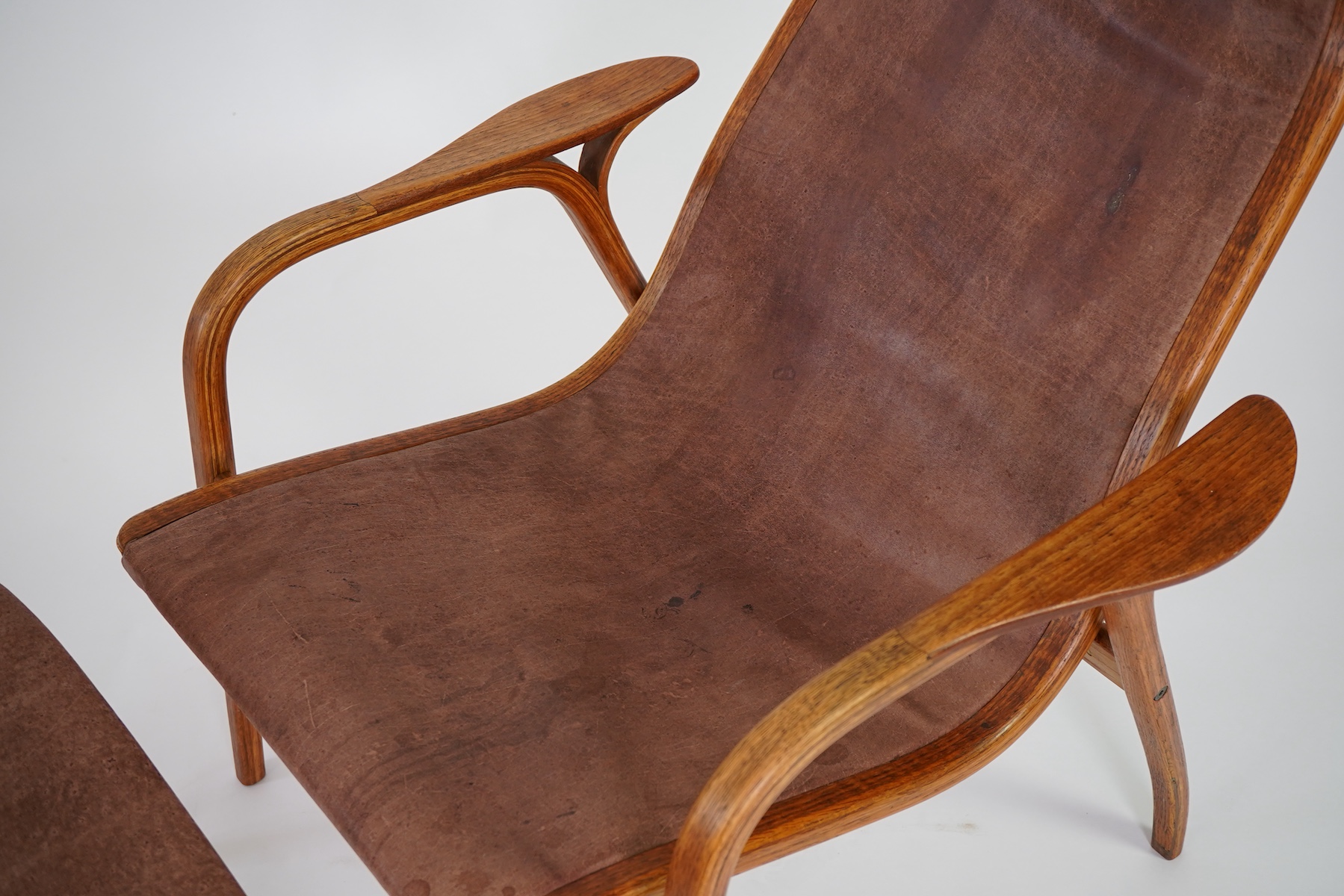 Yngve Ekström (Swedish, 1913-1998) for Swedese Möbler AB: A 'Lamino' oak lounge chair and ottoman